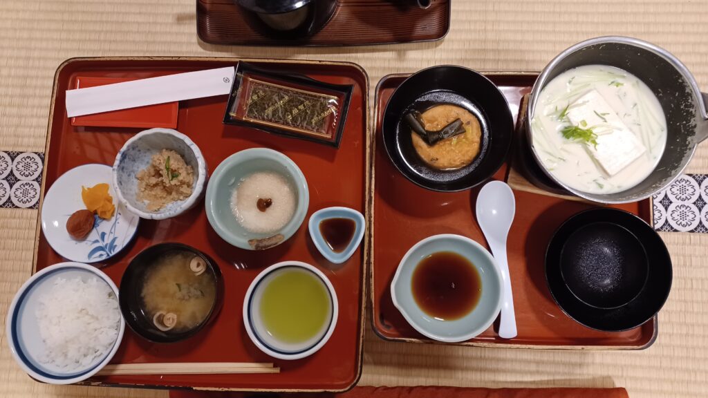 A nice selection of shojin ryori dishes: Rice, plums, green tea, miso soup, porridge, and tofu dishes.