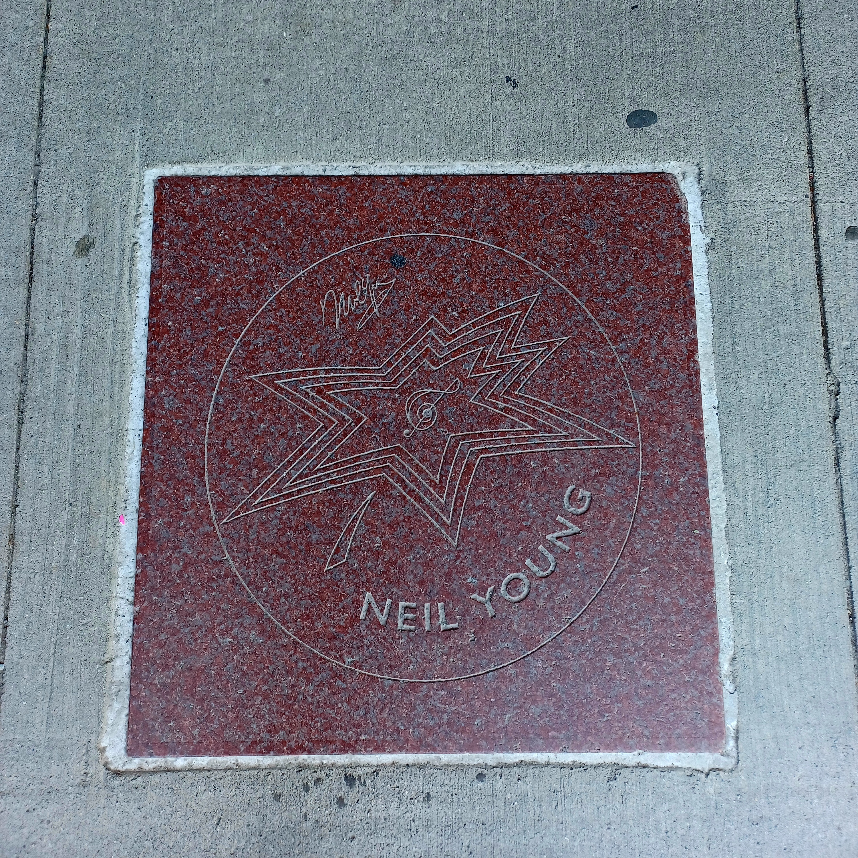 A red star shaped like a maple leaf, that says "Neil Young".