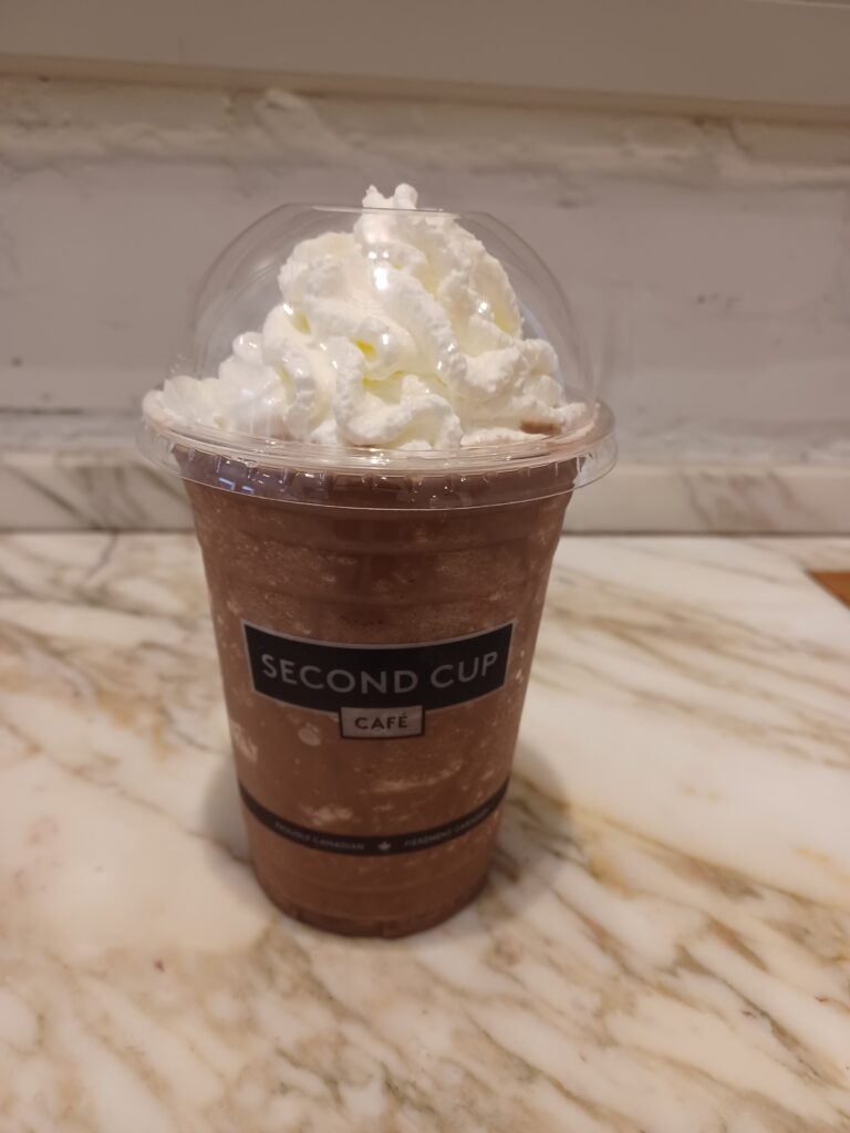 A frozen chocolate drink with lots of whipped cream on top!