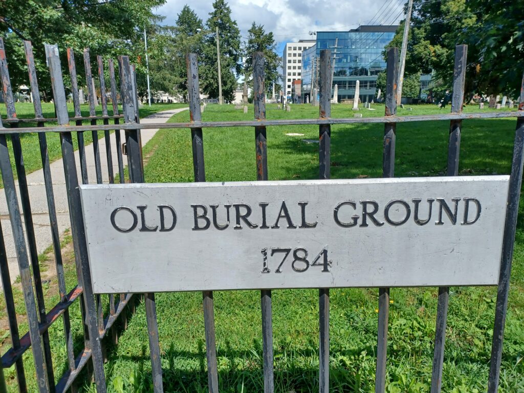 Entrance to the burial ground. The grey sign says "Old Burial Ground 1784".